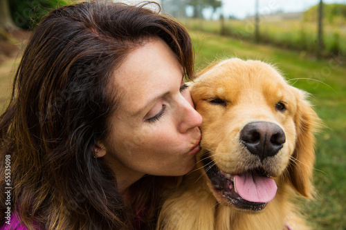 Photo: woman kissing her dog woman kissing her dog