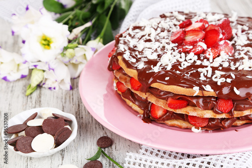 Photo: Chocolate cake on wooden table close-up Chocolate cake on wooden table close-up