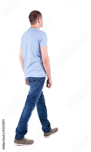 Photo: Back view of going handsome man in jeans Back view of going handsome man in jeans