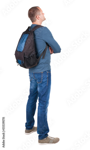 Photo: Back view of man with photographic backpack looking up Back view of man with photographic backpack looking up
