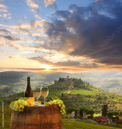 Photo: White wine with barell in vineyard, Chianti, Tuscany, Italy White wine with barell in vineyard, Chianti, Tuscany, Italy