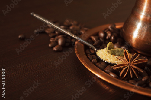 Photo: Closeup of cardamom pods, anise and brown sugar in a teaspoon Closeup of cardamom pods, anise and brown sugar in a teaspoon