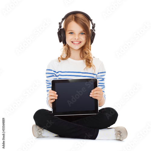 Photo: child with headphones showing tablet pc child with headphones showing tablet pc