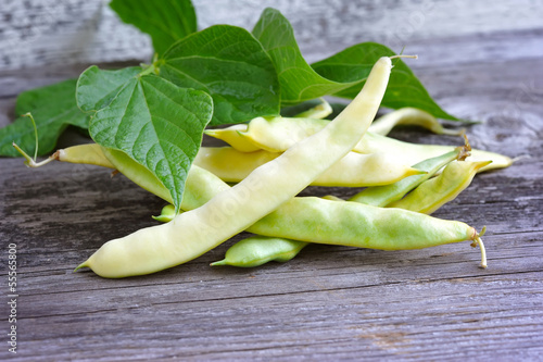 Photo: Yellow kidney beans on old wooden table Yellow kidney beans on old wooden table