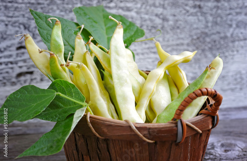 Photo: Yellow kidney beans in a basket on old wooden table Yellow kidney beans in a basket on old wooden table