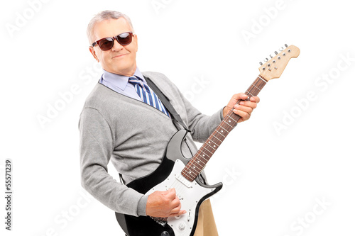 Photo: Smiling mature man playing guitar Smiling mature man playing guitar