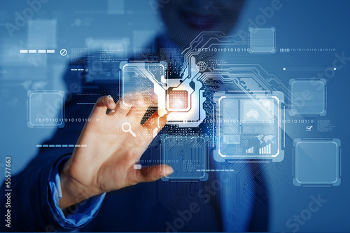 Photo: Businesswoman touching icon Businesswoman touching icon