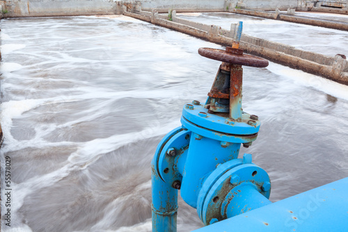 Photo: Industrial tap with blue pipeline for oxygen blowing into sewage Industrial tap with blue pipeline for oxygen blowing into sewage