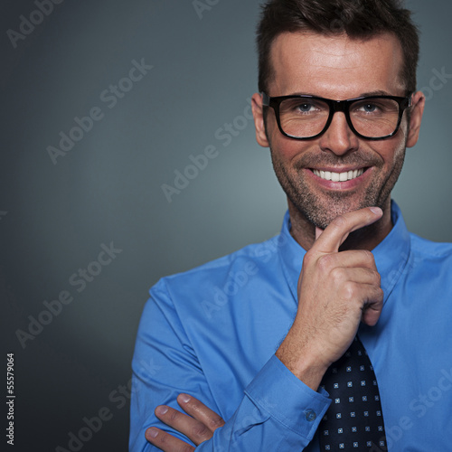 Photo: Handsome smug look man looking at camera Handsome smug look man looking at camera