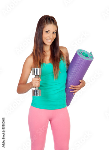 Photo: Funny girl in sportswear with a mat and dumbbell Funny girl in sportswear with a mat and dumbbell