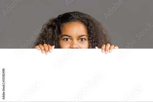 Photo: Girl looking over white Wall Girl looking over white Wall