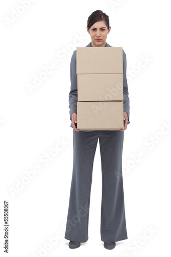 Photo: Businesswoman holding cardboard boxes Businesswoman holding cardboard boxes