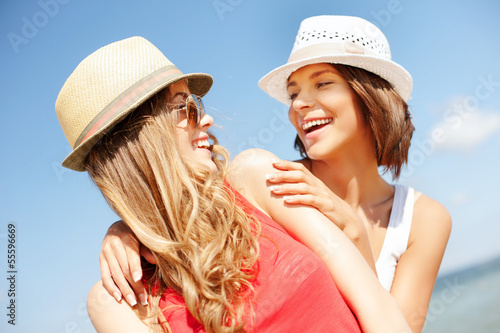 Photo: girls in hats on the beach girls in hats on the beach