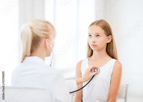 Photo: doctor with stethoscope listening to the patient doctor with stethoscope listening to the patient