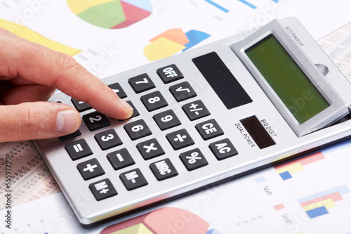 Photo: Accountant working with calculator. Accountant working with calculator.