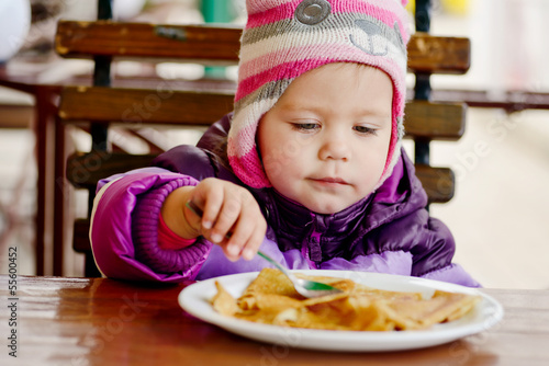 Photo: girl eating in cafe girl eating in cafe