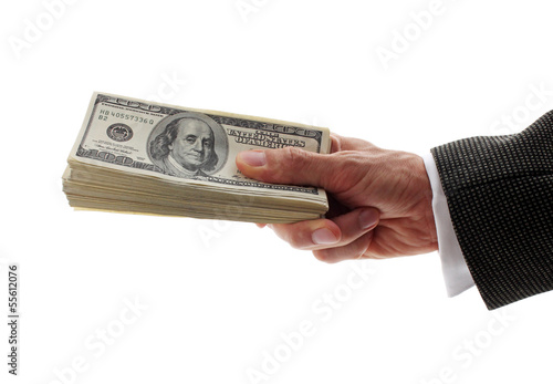 Photo: hand holding pile of dollars hand holding pile of dollars