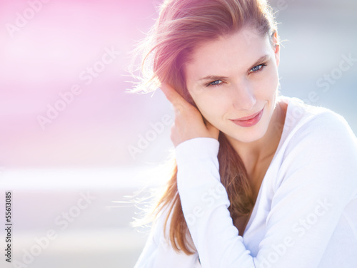 Photo: Delightful young woman touches her hair Delightful young woman touches her hair