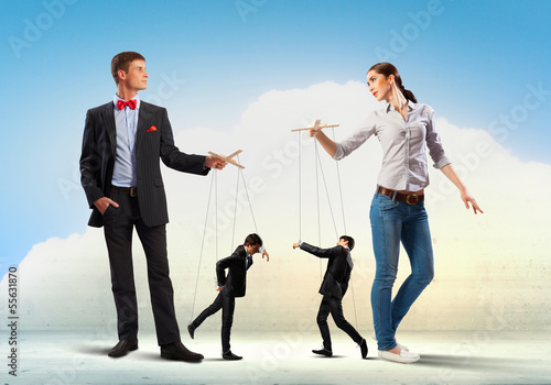 Photo: Businesspeople with marionettes Businesspeople with marionettes