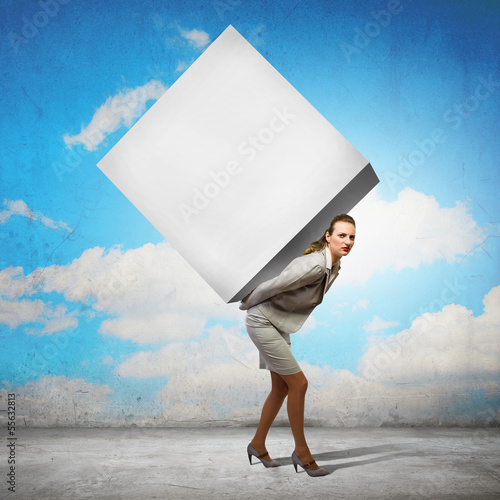 Photo: Businesswoman carrying cube Businesswoman carrying cube