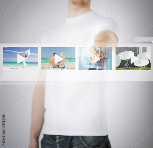 Photo: man pressing button on virtual screen man pressing button on virtual screen