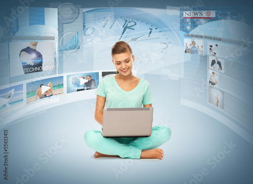 Photo: woman with laptop pc and virtual screens woman with laptop pc and virtual screens
