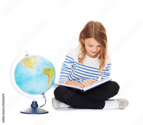 Photo: girl with globe and book girl with globe and book