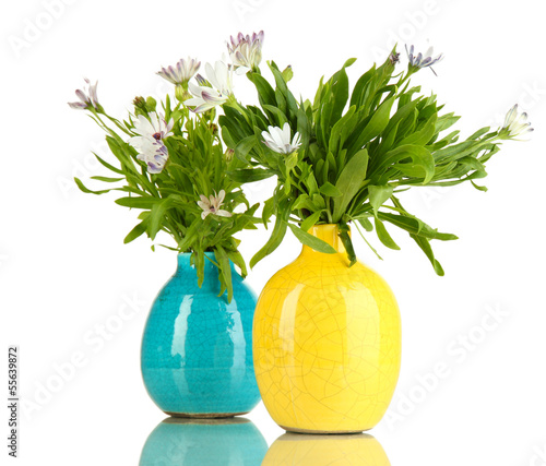 Photo: Bouquet of beautiful summer flowers in color vases, isolated Bouquet of beautiful summer flowers in color vases, isolated