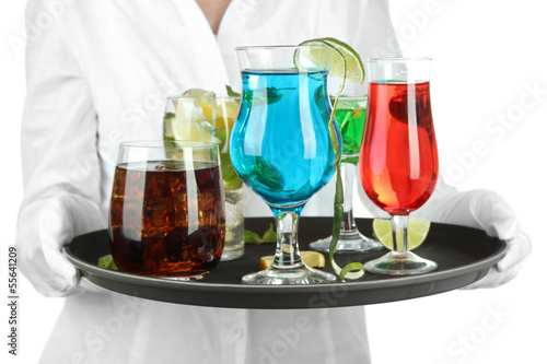 Photo: Waitresses holding tray with glasses of cocktails, isolated Waitresses holding tray with glasses of cocktails, isolated