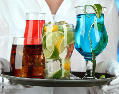 Photo: Waitresses holding tray with glasses of cocktails Waitresses holding tray with glasses of cocktails