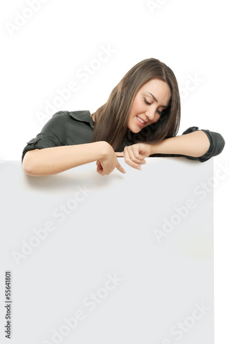 Photo: A smiling woman standing near blank A smiling woman standing near blank
