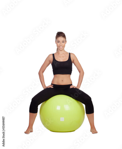 Photo: Young beautiful woman sitting on a gymnastic ball Young beautiful woman sitting on a gymnastic ball