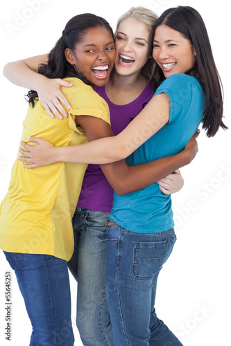 Photo: Diverse laughing women embracing each other Diverse laughing women embracing each other