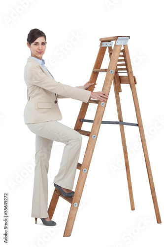 Photo: Businesswoman climbing career ladder Businesswoman climbing career ladder