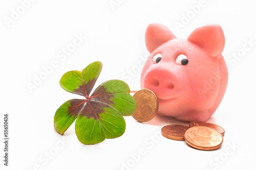 Photo: Four-leafed clover and piggybank Four-leafed clover and piggybank