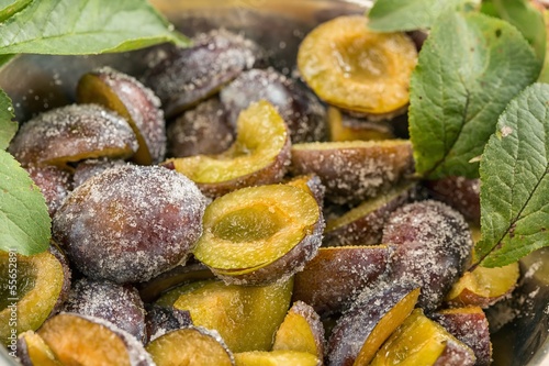 Photo: Bowl halved plums sprinkled with sugar Bowl halved plums sprinkled with sugar