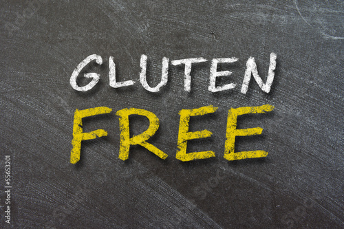Photo: Gluten Free handwritten with white chalk on a blackboard. Gluten Free handwritten with white chalk on a blackboard.