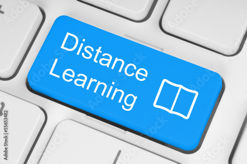 Photo: Blue distance learning button on white keyboard. Blue distance learning button on white keyboard.