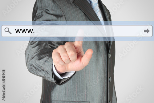 Photo: Businessman pushing virtual search bar on grey background Businessman pushing virtual search bar on grey background