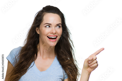 Photo: Happy Woman pointing at copy-space. Happy Woman pointing at copy-space.