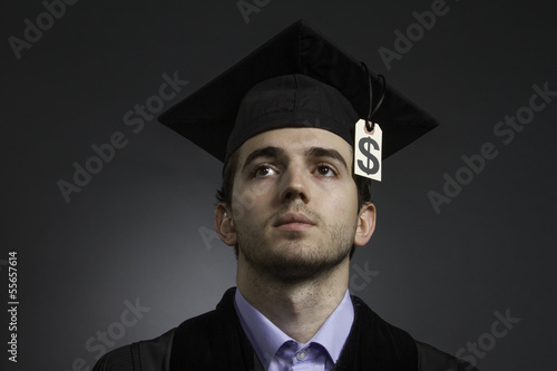 Photo: College graduate with large tuition bill, horizontal College graduate with large tuition bill, horizontal