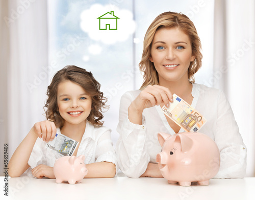 Photo: mother and daughter saving money mother and daughter saving money