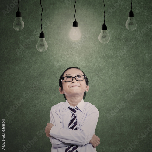 Photo: Close-up young businessman under lamps Close-up young businessman under lamps