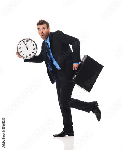 Photo: Businessman running late for a meeting Businessman running late for a meeting