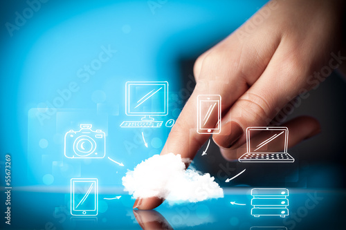 Photo: Finger pointing on tablet pc, mobile cloud concept Finger pointing on tablet pc, mobile cloud concept