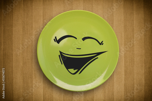 Photo: Happy smiley cartoon face on colorful dish plate Happy smiley cartoon face on colorful dish plate
