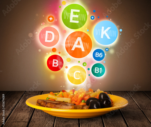 Photo: Food plate with delicious meal and healthy vitamin symbols Food plate with delicious meal and healthy vitamin symbols