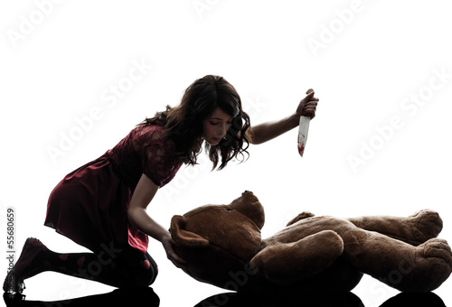 Photo: strange young woman killing her teddy bear silhouette strange young woman killing her teddy bear silhouette