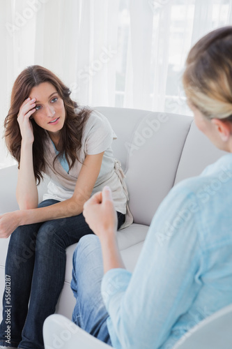 Photo: Upset woman sitting with her therapist talking to her Upset woman sitting with her therapist talking to her