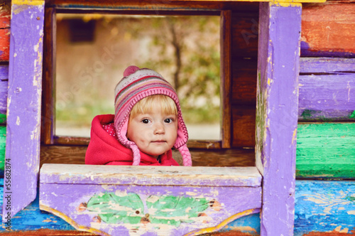 Photo: baby girl in wooden house baby girl in wooden house